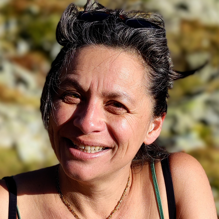 Barber 1 young man with beard smiling and wearing a brown shirt