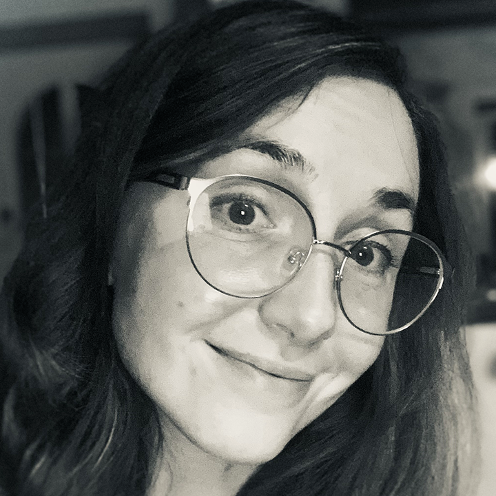 Barber 1 young man with beard smiling and wearing a brown shirt